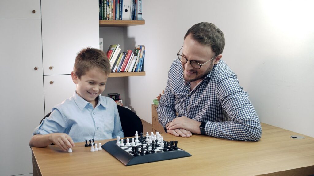 m810 father and boy playing chess 2 1440x1440